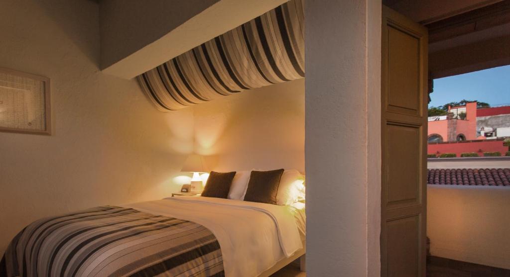 Postel nebo postele na pokoji v ubytování Hotel Boutique El Palomar