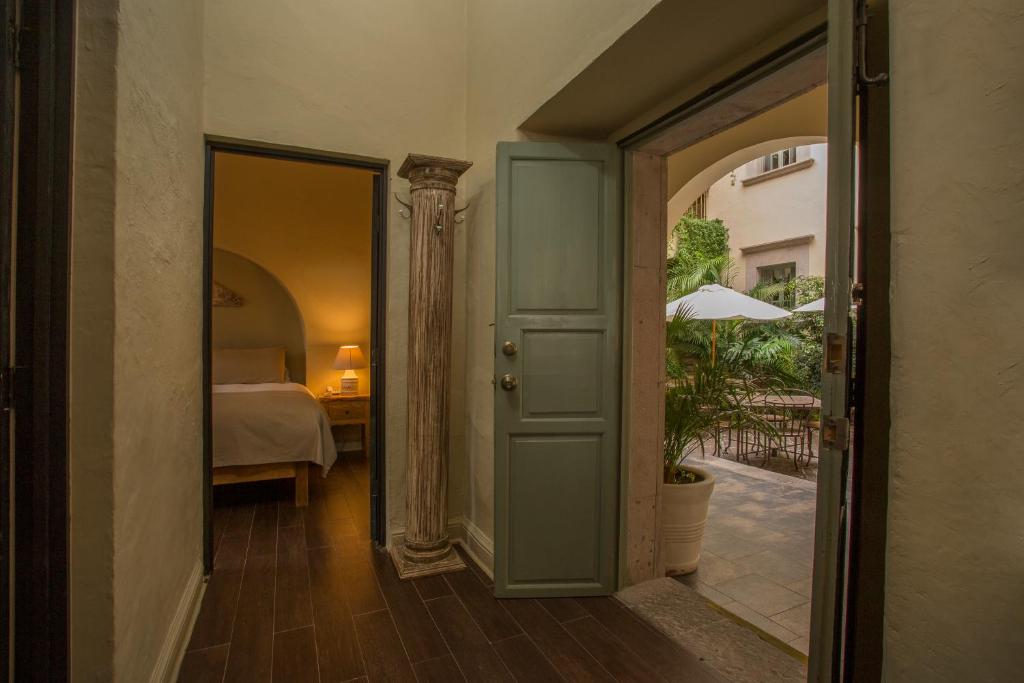 Postel nebo postele na pokoji v ubytování Hotel Boutique El Palomar