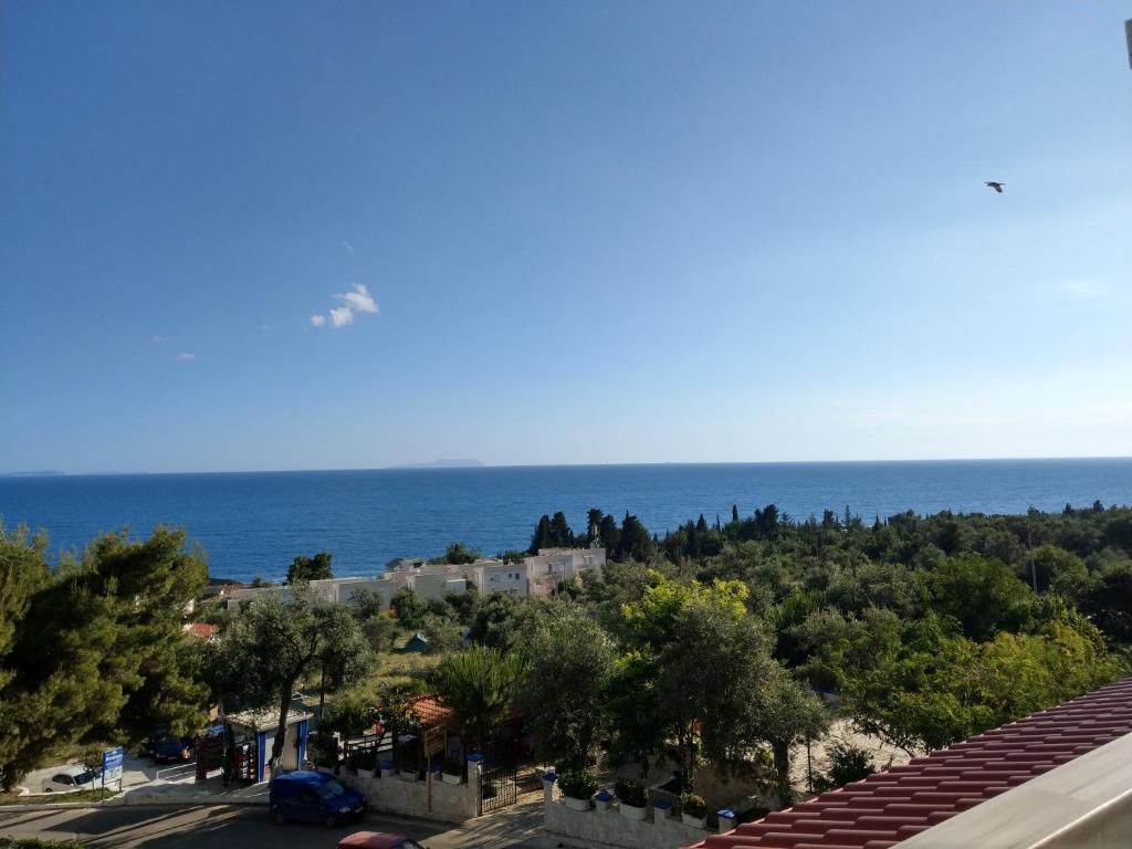 a view of the ocean from a building at Augustus Hotel in Dhërmi