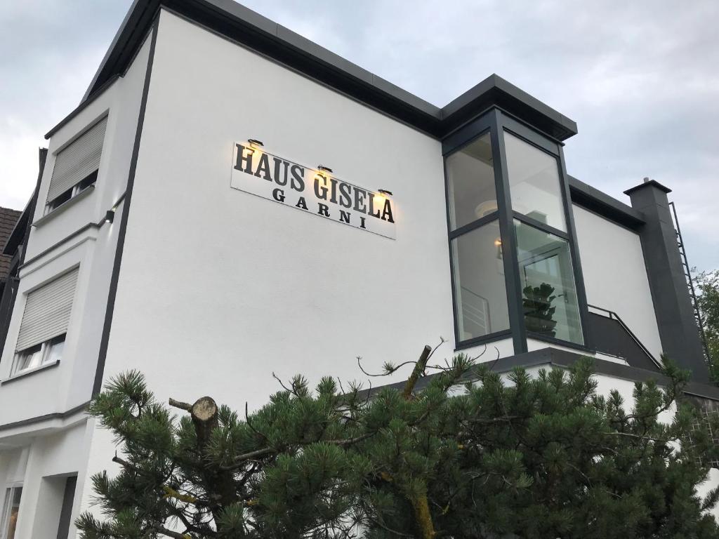 a white building with a sign on the side of it at Gästehaus Gisela in Bad Dürrheim