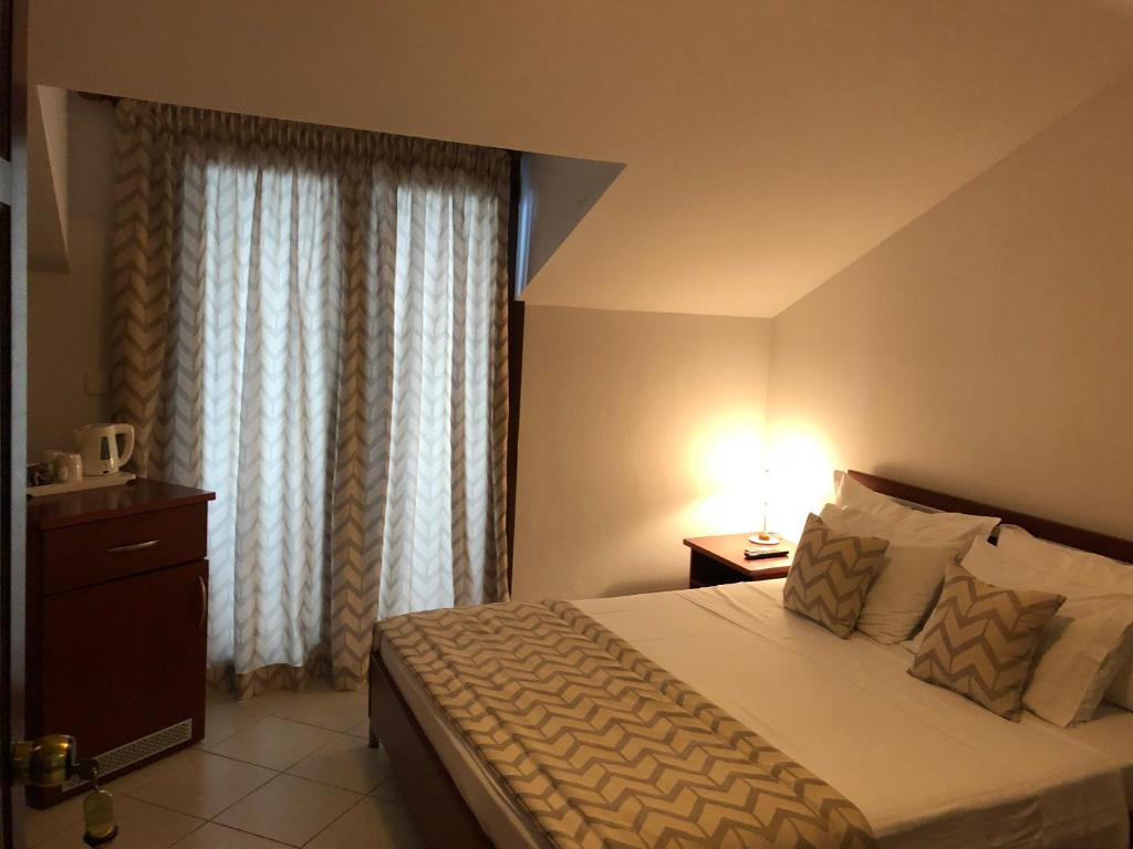 Postel nebo postele na pokoji v ubytování Ammouliani Hotel