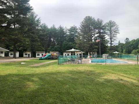 a park with a swimming pool and a playground at Catskill Motor Court in Catskill