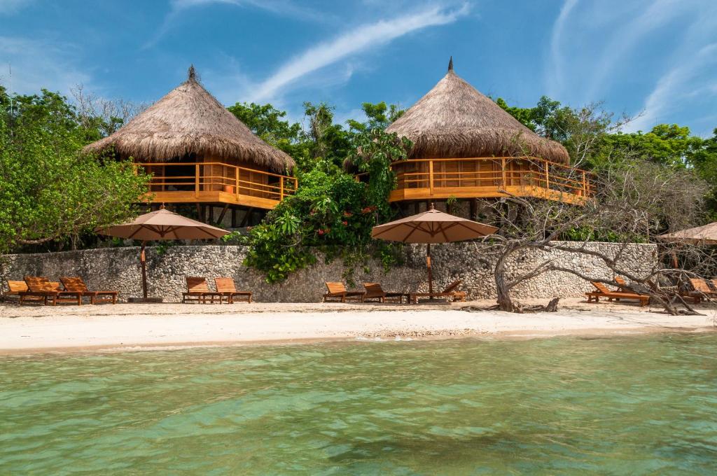 ein Resort am Strand mit Liegestühlen und Sonnenschirmen in der Unterkunft Hotel Las Islas in Barú