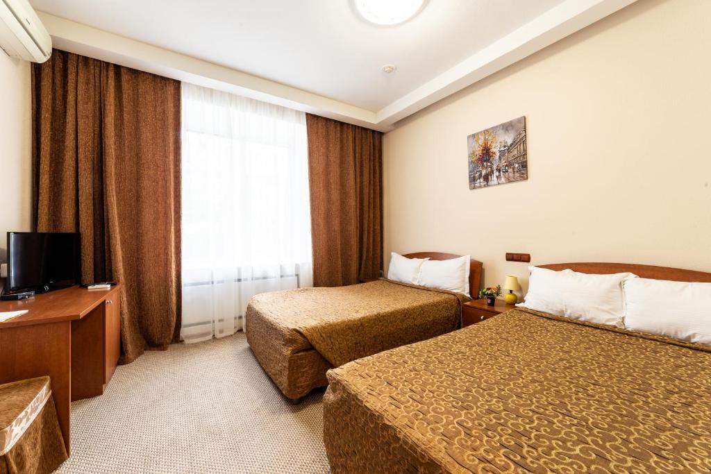 מיטה או מיטות בחדר ב-Onezhsky Hotel
