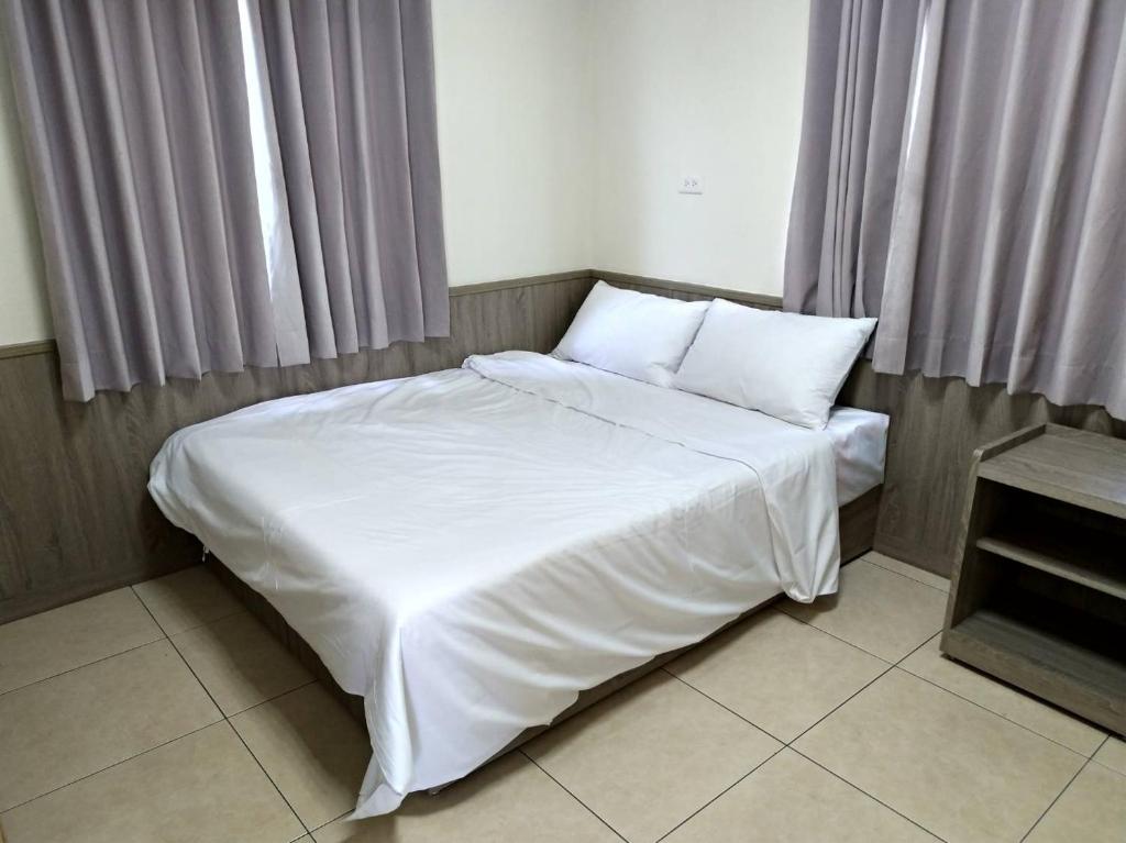 Postel nebo postele na pokoji v ubytování Yahweh Homestay