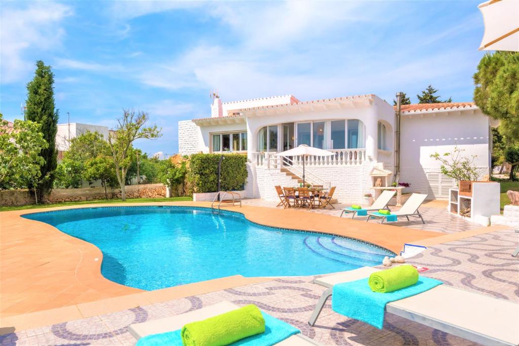 a villa with a swimming pool and a house at Villa Roqueta in Sant Lluis