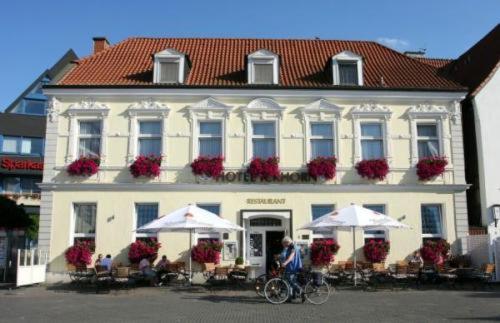 a person riding a bike in front of a building at Hotel Ickhorn in Werne an der Lippe