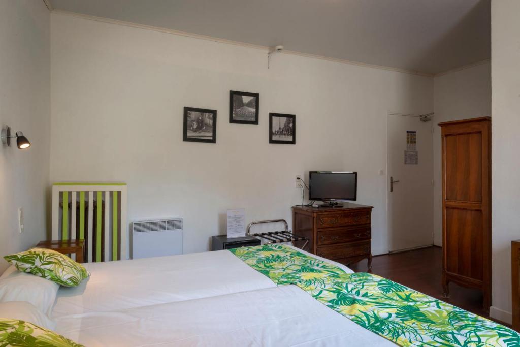 Postel nebo postele na pokoji v ubytování Hotel Du Forum