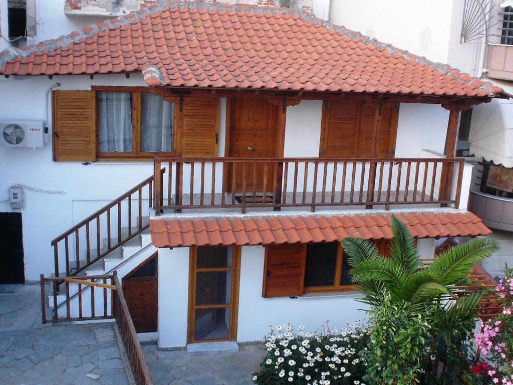 a house with a deck and a staircase at Traditional House Paschalis in Kavála