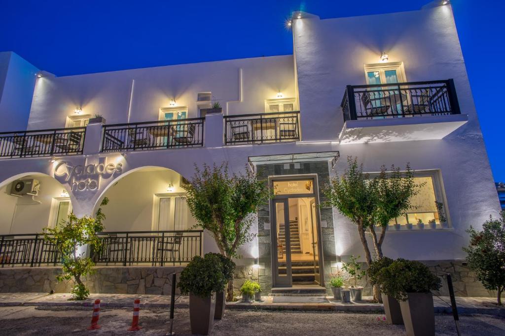 a white building with a door at night at Hotel Cyclades in Parikia