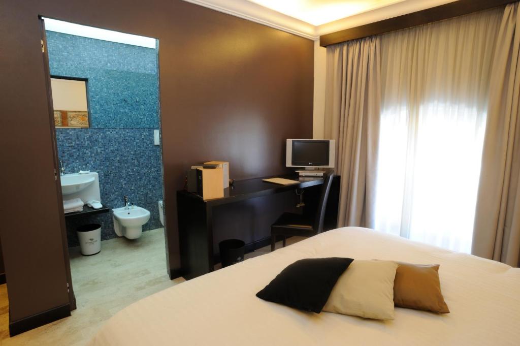 Postel nebo postele na pokoji v ubytování Ucciardhome Hotel