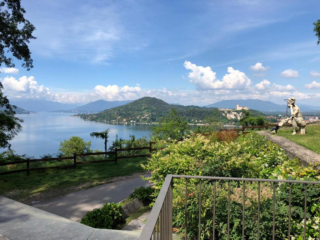 a view of a body of water with a statue at La Casa nel Parco in Arona