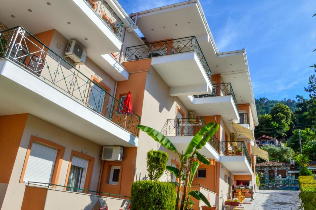 an apartment building with balconies and a courtyard at Vergina in Skala Potamias