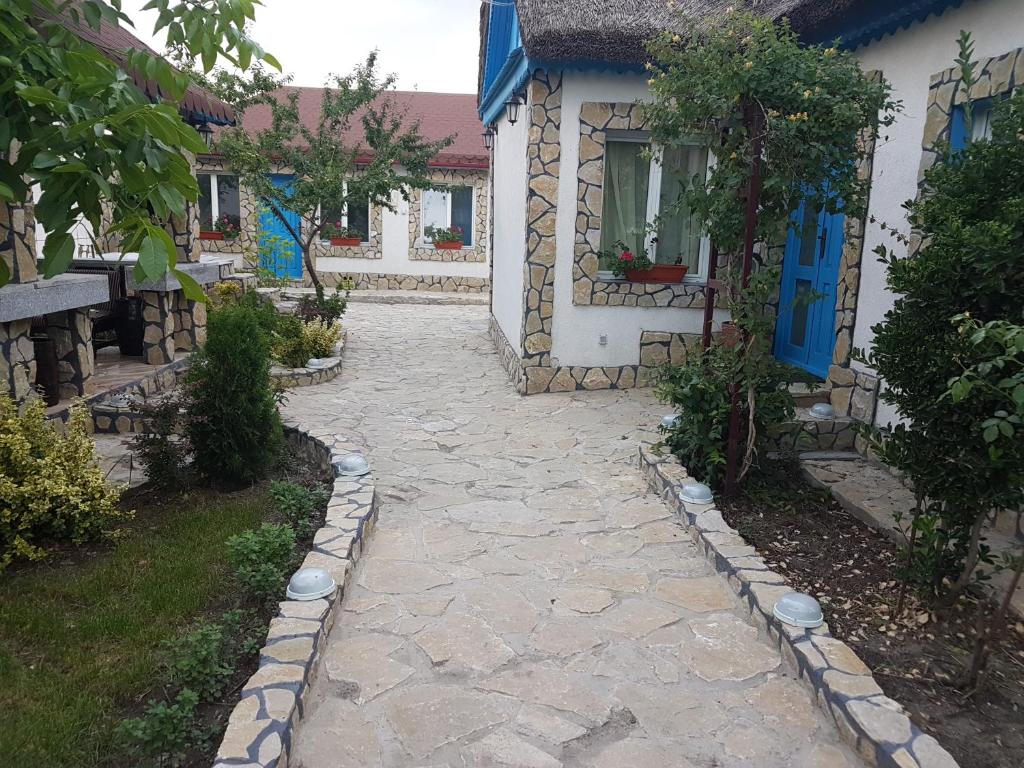a stone walkway in front of a house at Casa Anica in Sulina