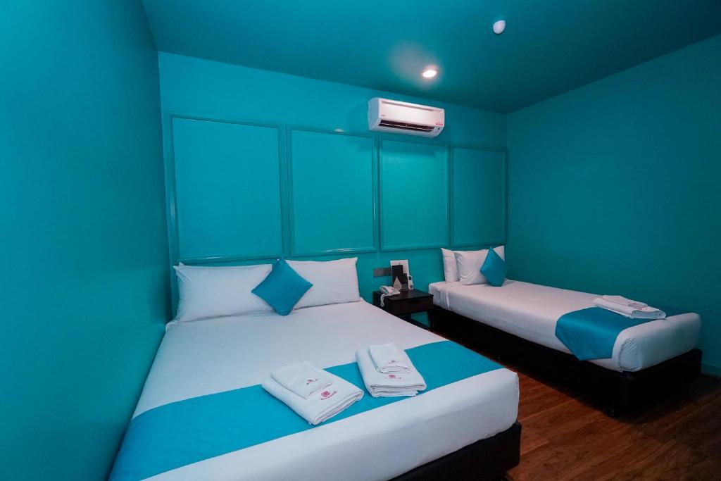 Postel nebo postele na pokoji v ubytování Bloommaze Boutique Hotel Puchong