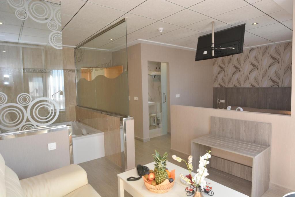 
a living room filled with furniture and a large mirror at Torrejoven in Torrevieja
