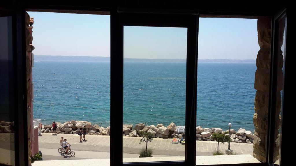 a view of the ocean from a window at Punta Nana Mira in Piran