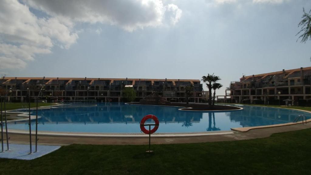 a large swimming pool in front of some apartment buildings at Golf Panoramica in Sant Jordi