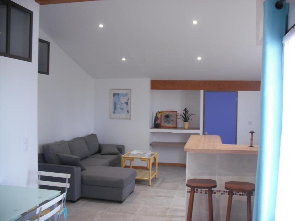 uma sala de estar com um sofá e uma mesa em Appartement Palm'Ares em Arès