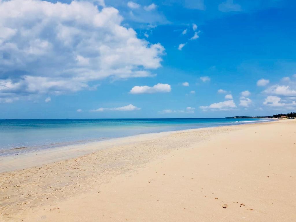 a beach with a blue sky and the ocean at Beach Paradise Nilaveli in Trincomalee
