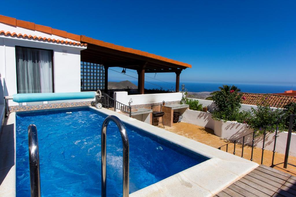 a swimming pool on the side of a house at Varanski Vista in San Miguel de Abona