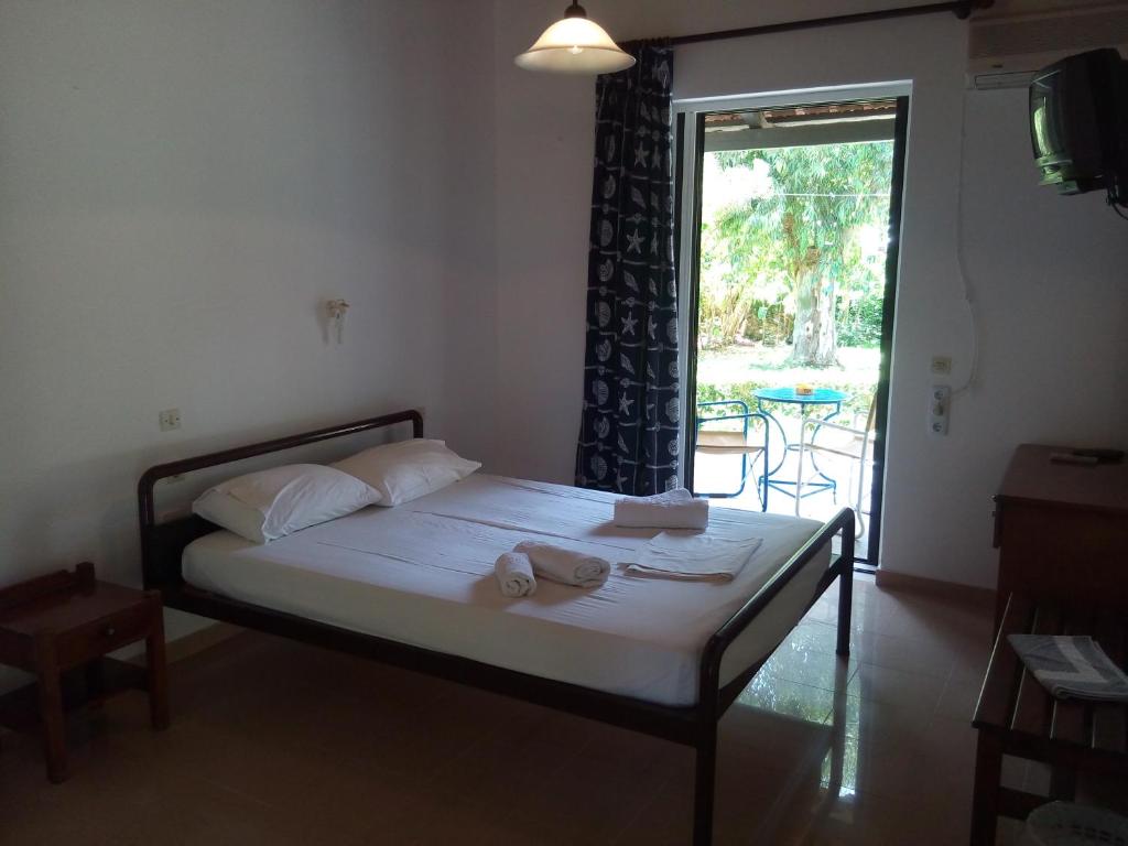 Postel nebo postele na pokoji v ubytování Hotel Dougas