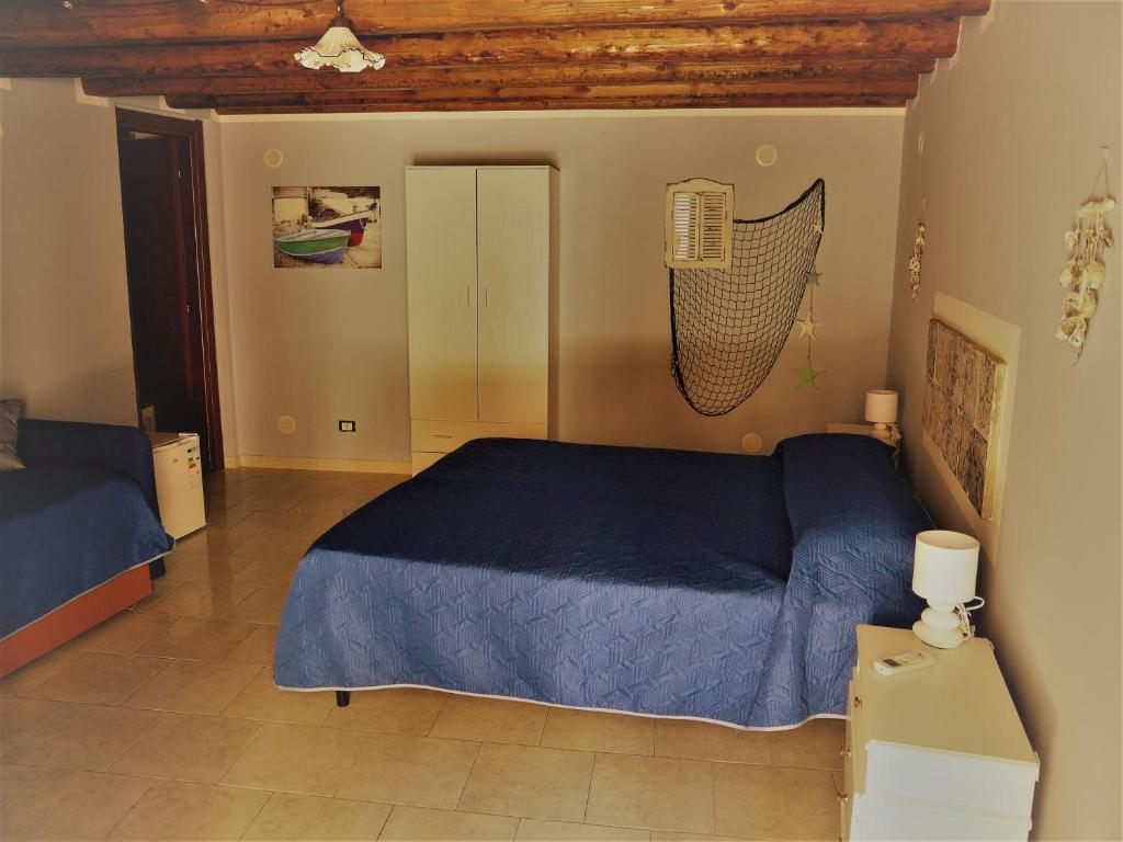 a bedroom with a blue bed in a room at A Vanedda in Termini Imerese
