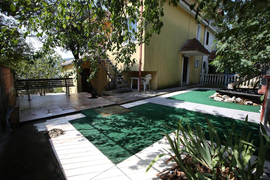 a backyard with a pool with green grass at House by the Sea in Herceg-Novi