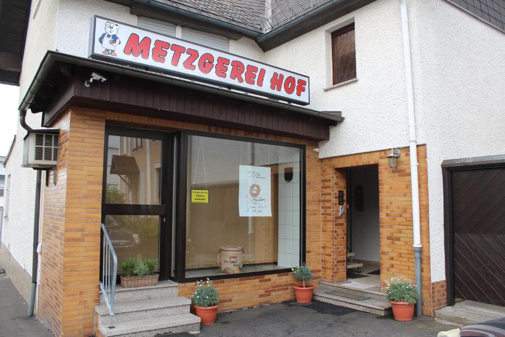 a mertonethhydehyderessoressoastery with a sign on the front at Casa Metzjersch in Gemünden