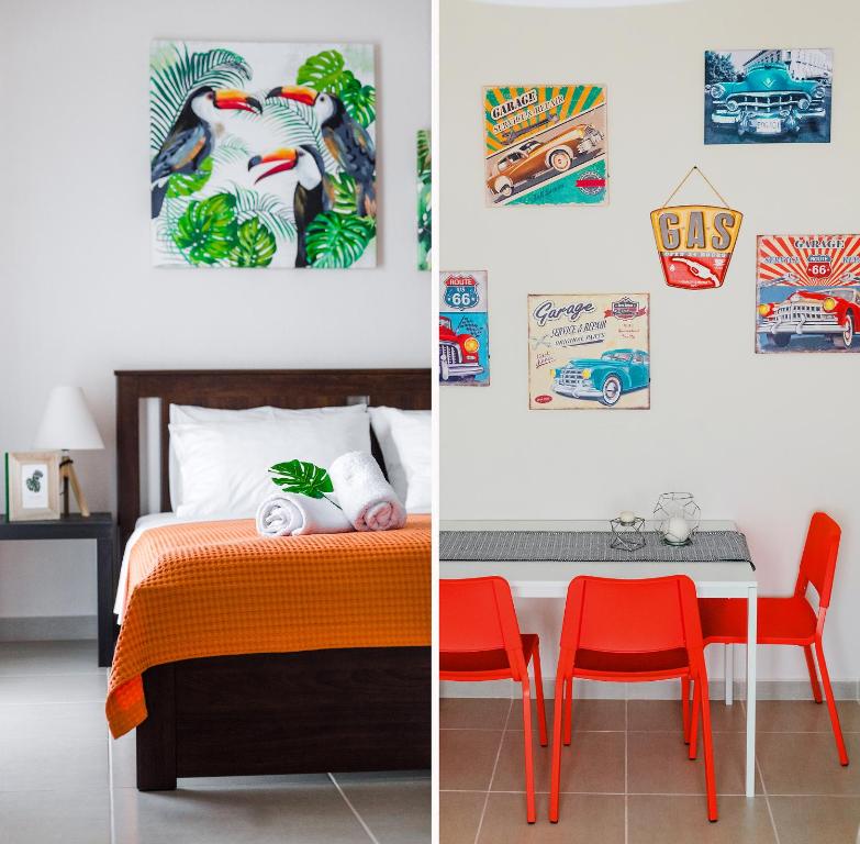a bedroom with a bed and a table with a red chair at Sea Breeze Flat in Kavala