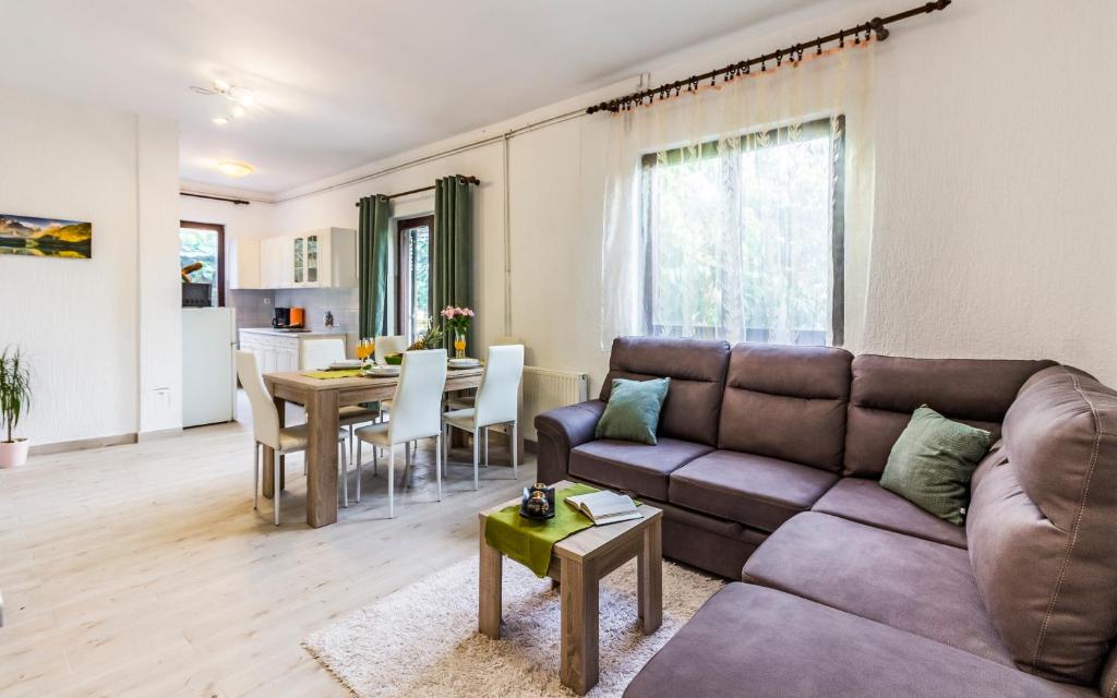 a living room with a couch and a table at Apartments Tamara in Medulin