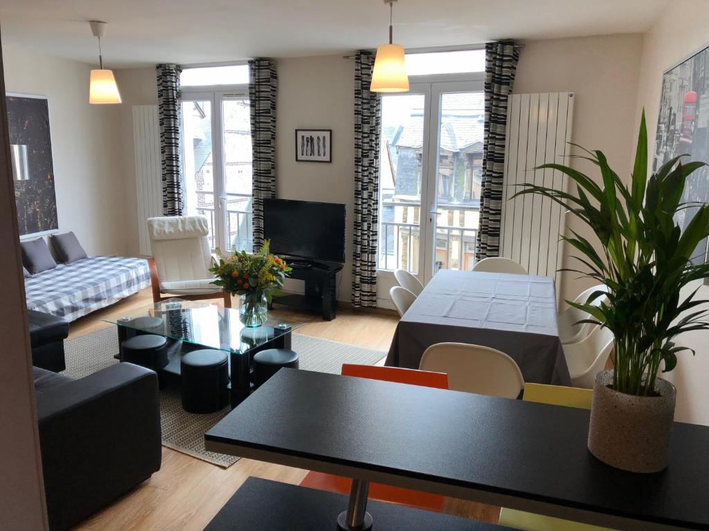 a living room with a couch and a table at Rouen Quartier St Maclou in Rouen