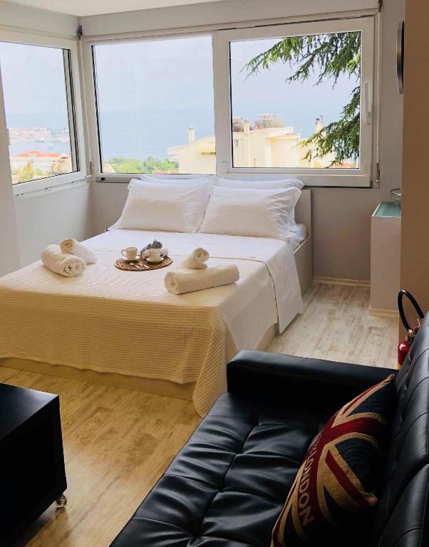 a bedroom with a large bed with towels on it at K&B Luxury Studios in Kavála