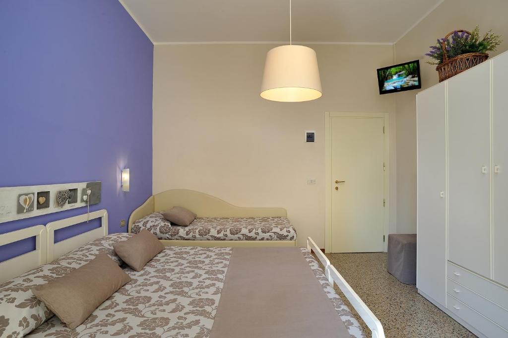 A bed or beds in a room at Hotel Roma