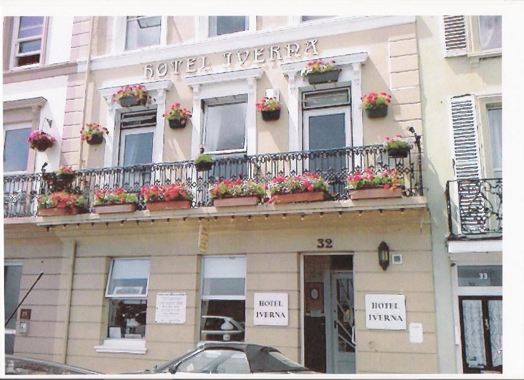 a building with flower boxes on a balcony at The Iverna in Eastbourne