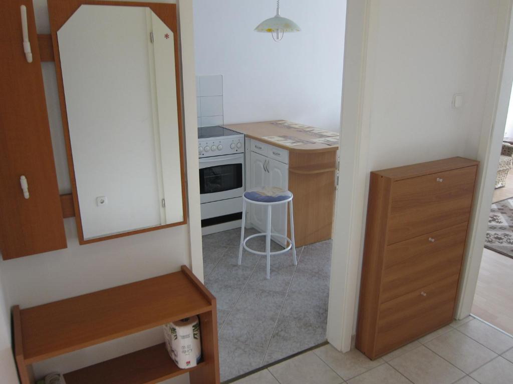a kitchen with a white refrigerator and a stool at Erdélyi vendégház in Sárospatak