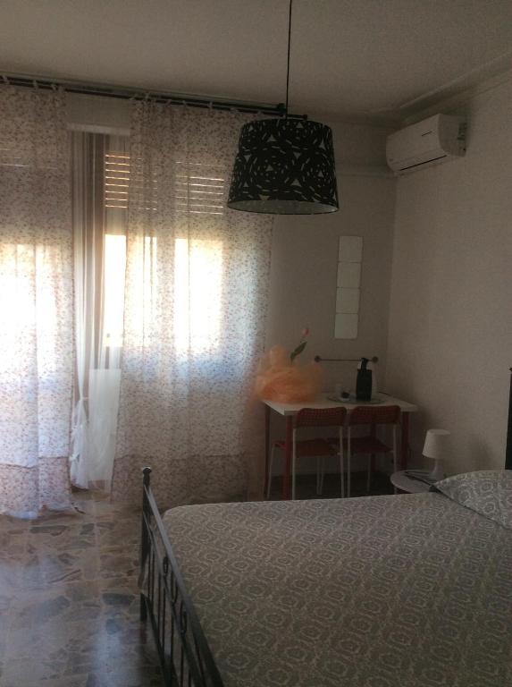 1 dormitorio con cama, mesa y ventana en Casa Giulia In, en Pisa