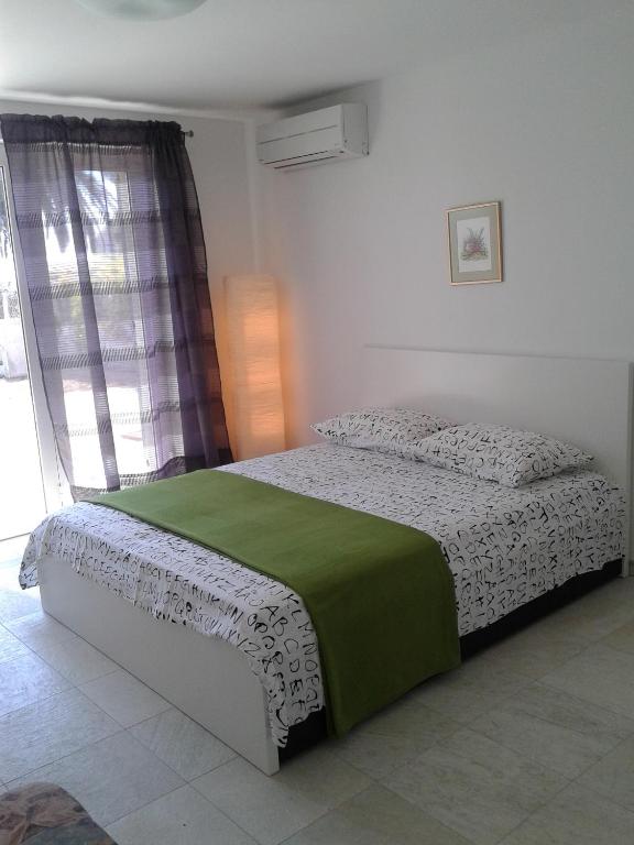 Postel nebo postele na pokoji v ubytování Apartment Ika