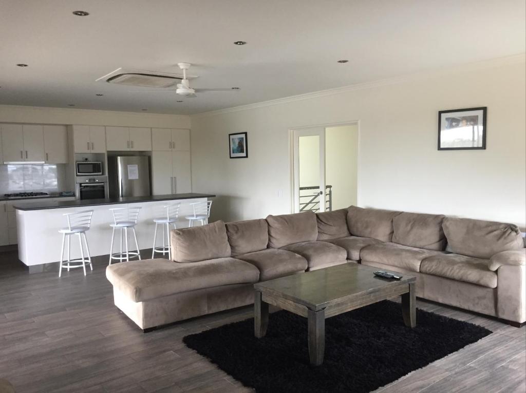 a living room with a couch and a table at Blue Sky Apartment in Jurien Bay