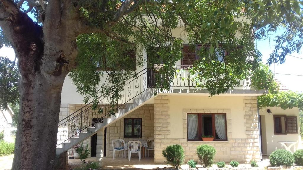 a house with a staircase in front of it at Family friendly holiday home "Ana" in Šibenik