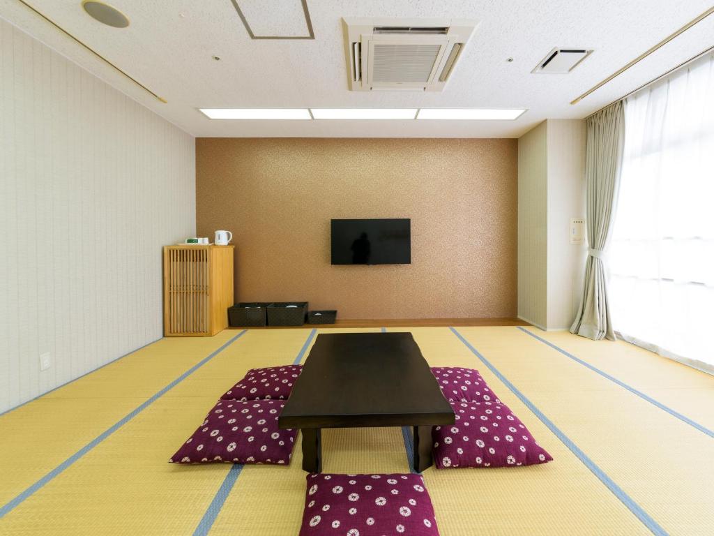 a conference room with a table and purple mats at Hotel Abest Naha Kokusaidori in Naha