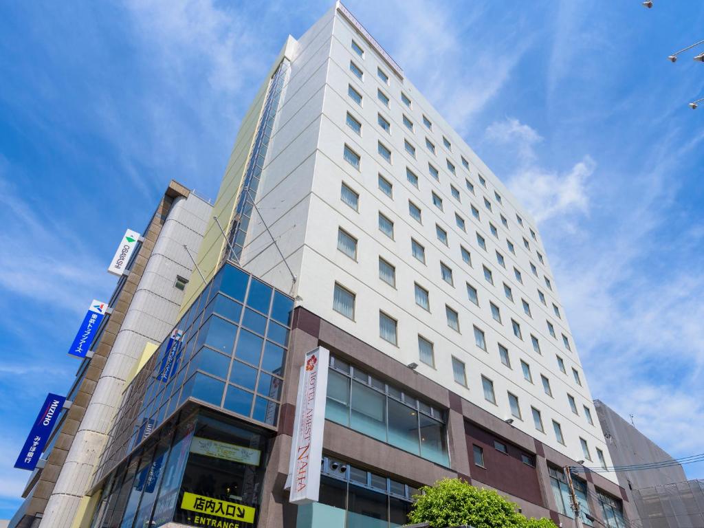 a tall white building with a lot of windows at Hotel Abest Naha Kokusaidori in Naha