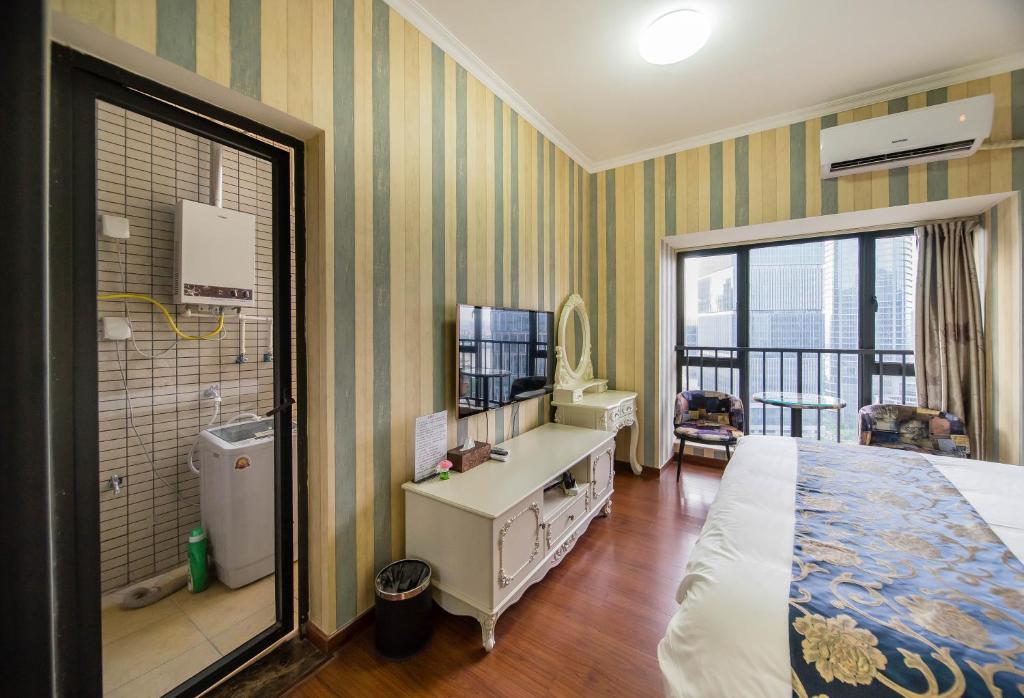 a hotel room with a bed and a balcony at Xing Yu Legend Service Apartment Canton Fair Branch in Guangzhou