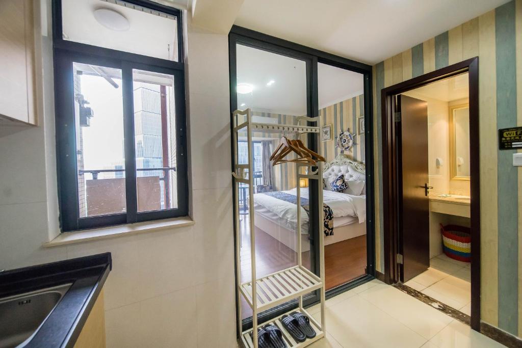 a bathroom with a mirror and a bed in a room at Xing Yu Legend Service Apartment Canton Fair Branch in Guangzhou