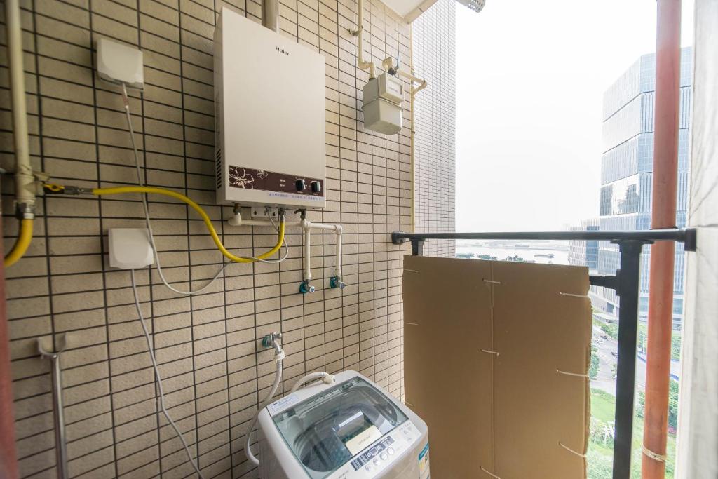 a bathroom with a urinal and a toilet at Xing Yu Legend Service Apartment Canton Fair Branch in Guangzhou