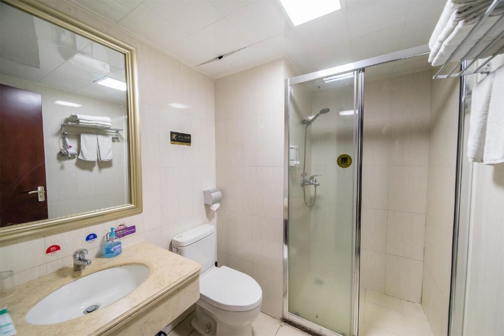 a bathroom with a shower and a toilet and a sink at Xing Yu Legend Service Apartment Canton Fair Branch in Guangzhou
