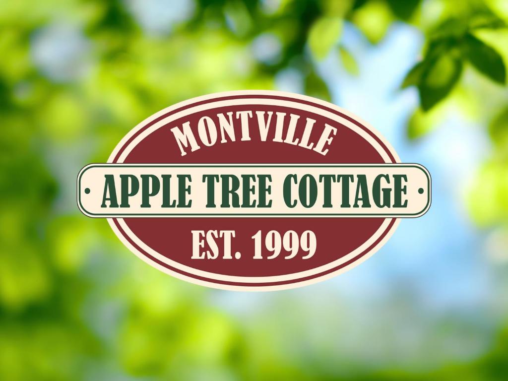 an apple tree office sign in front of trees at Apple Tree Cottage Montville in Montville