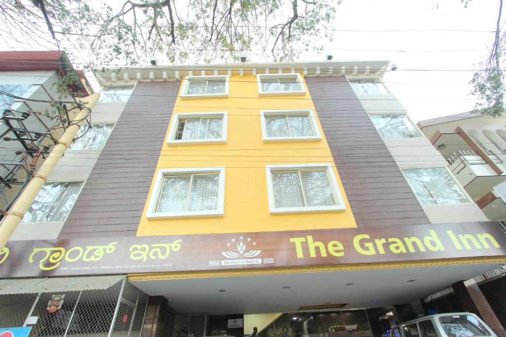 a building with the grand inn in front of it at The Grand Inn Mysore in Mysore