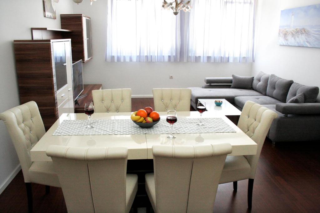 a living room with a table with a bowl of fruit on it at Apartment MEL II in Split