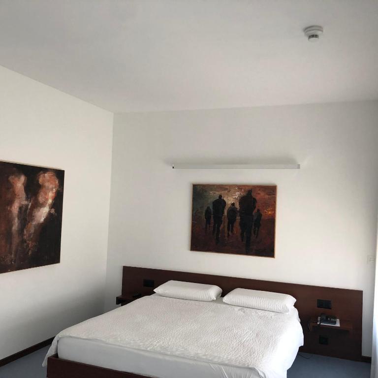Ein Bett oder Betten in einem Zimmer der Unterkunft Hotel Ceresio
